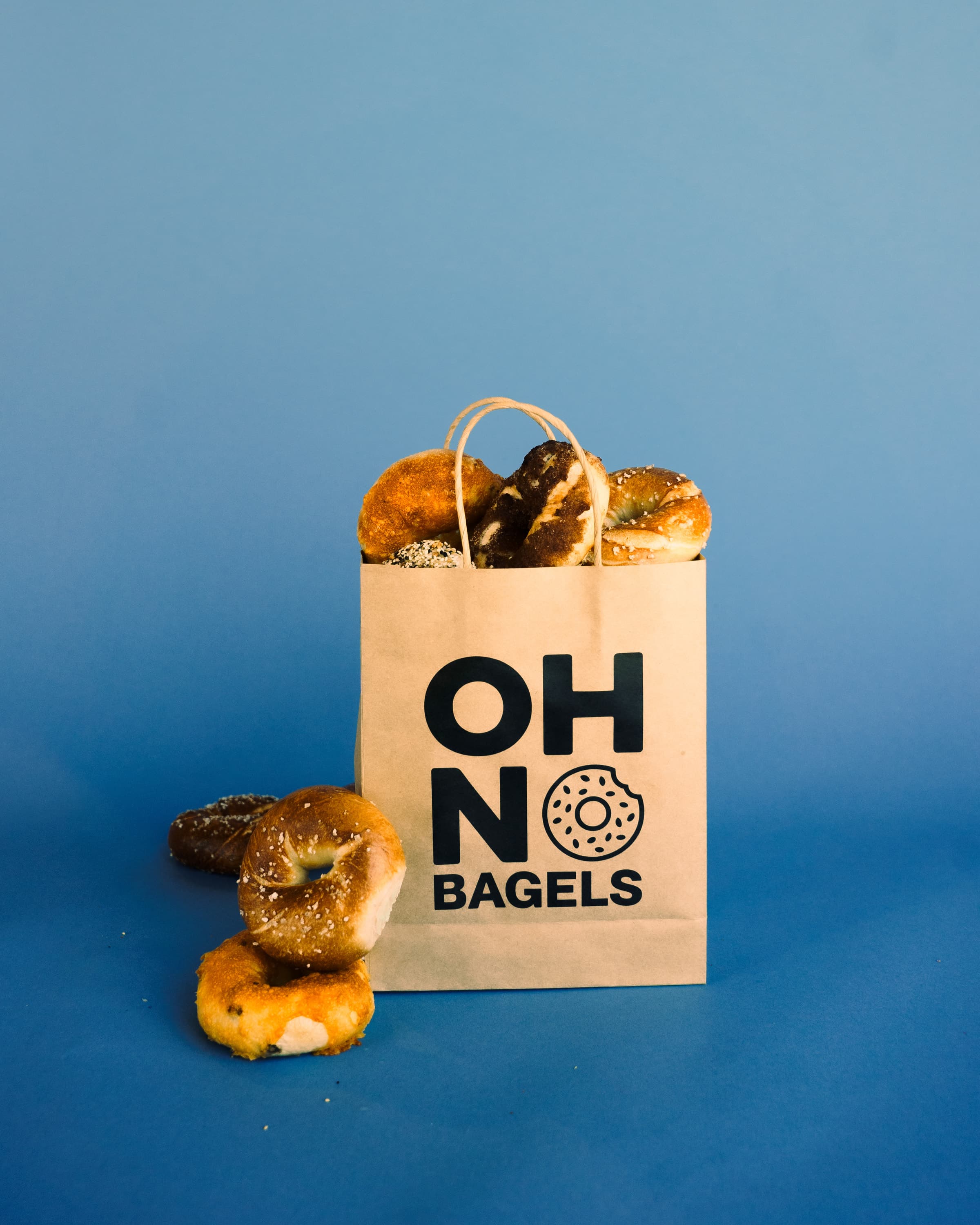 An Oh No Bagels bag filled with fresh bagels